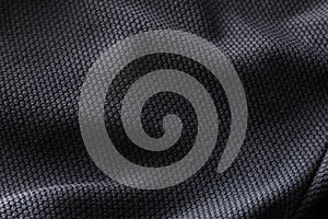 Close-up polyester fabric texture of black athletic shirt