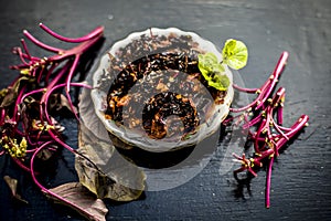 Close up of popular dish of amaranth leaves or chauli or chowli or chaulai or thotakura or harive soppu in a glass plate with raw