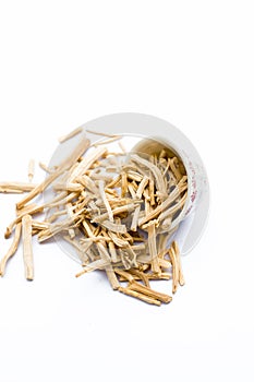 Close up of popular Indian and Asian ayurvedic herb i.e. Satavari or kurilo isolated on white in a glass bowl.