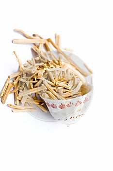 Close up of popular Indian and Asian ayurvedic herb i.e. Satavari or kurilo isolated on white in a glass bowl.