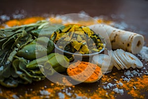 Close up of popular Indian & Asian white radish salad or muli ka smabara on wooden surface with white cut radish and its leaves wi