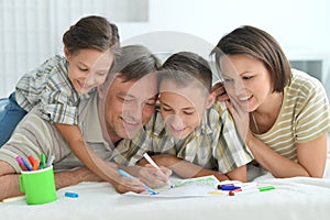 Porait of happy family drawing at home photo