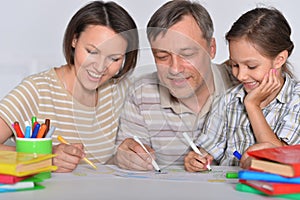 Porait of happy family drawing at home photo