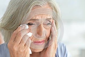 Close up porait of stressed senior woman photo