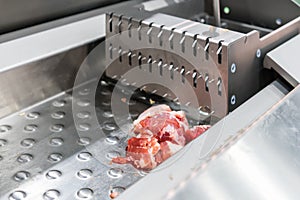 Close up pork or meat sliced on metal rail transport food of automatic and precision slicer machine for industrial food
