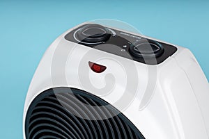 Close up of portable electric heater. Blue background