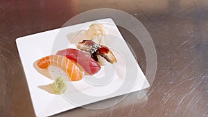 Close-up portion of delicious sashimi with rice and fresh fish on a white plate. Copy space.