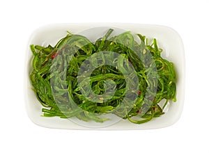 Close up portion of green wakame seaweed salad