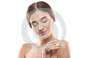 Close-up portrait of a 30 years old woman with closed eyes and clean skin natural makeup  on white background.
