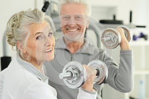 Close up portrait of active smiling senior couple exercising