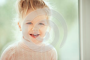 Close up portrait of adorable beautiful baby girl smiling and looking to cam. Childhood Kids People concepts. Caucasian Fashion Be