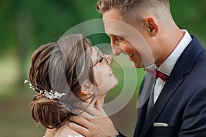 Close up portrait affectionate, cheerful bride and groom caring each other, embracing face to face on wedding event