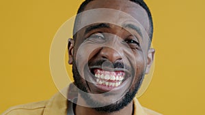 Close-up portrait of African American guy laughing and having fun enjoying funny joke