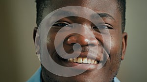 Close up portrait African American man male student ethnic guy smiling businessman looking at camera dental toothy smile