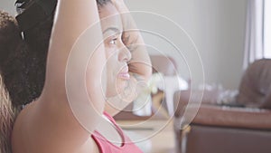 Close up portrait African American woman wearing in the virtual reality headset sitting on the armchair at home. Woman