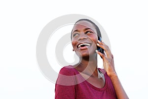 Close up african american young woman talking on cell phone isolated over white background