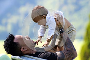 Close up portrait of afro american father kissing multiracial baby. Father hug Biracial child. Father with Biracial baby