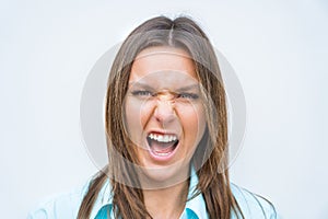 Close up portrait of angry mad woman face. Female screaming or shouting. Concerned and stressed woman