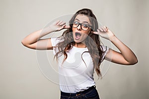 Close up portrait of angry stressed out young woman plugging ears with fingers and closing eyes tight, irritated with loud annoyin