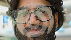 Close up portrait Arabian bearded smiling cheerful positive carefree man in glasses Indian CEO pensive Muslim worker
