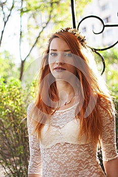 Close-up portrait of arrogant beautiful slim girl with long red hair