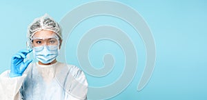 Close up portrait of asian female doctor, nurse in personal protective equipment showing syringe with vaccine