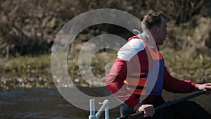 Close up portrait of Athlete rowing on the river in a canoe. Rowing, canoeing, paddling. Training. Kayaking. Man sailing