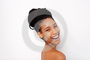 Close up attractive african woman laughing with naked shoulders on white background