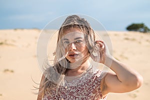 Close-up portrait of attractive caucasian young woman desert.