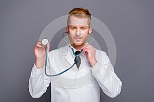 Close up portrait of attractive doctor hold stethoscope in ears