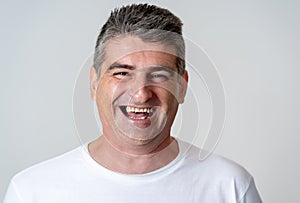 Close up portrait of an attractive middle aged man having fun and looking happy joyful smiling and laughing at the camera in human