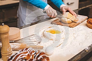 Close-up portrait of attractive senior aged woman is cooking on kitchen. Grandmother making tasty baking