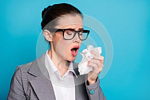 Close-up portrait of attractive sick lady teacher sneezing having flu using napkin isolated over bright blue color