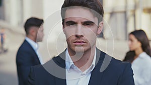 Close up portrait of attractive young business man entrepreneur looking serious at camera ambitious male leadership