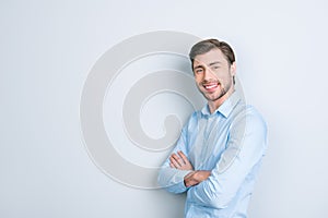 Close up portrait of attractive young entrepreneur with arms fol