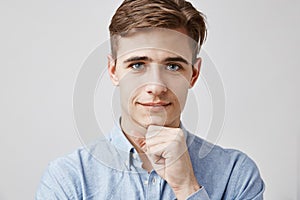 Close up portrait of attractive young guy. Please, talk, I am listening. Handsome young man hears problems of his