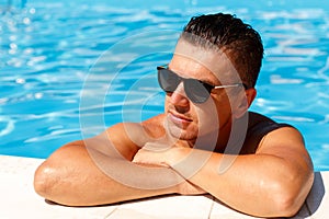 Close up portrait of attractive young man in sunglasses resting