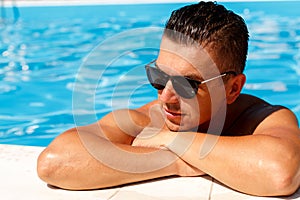 Close up portrait of attractive young man in sunglasses resting