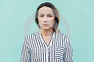 Close up, portrait bad mood business woman. Unhappy business woman looking at camera with tired face.