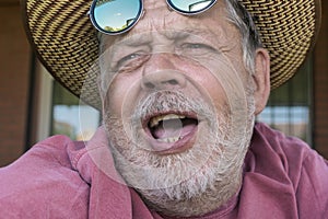 Portrait of bearded singing senior man