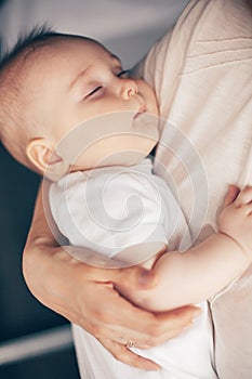 Close up portrait of beautiful baby boy sleeping in mother hands. Healthcare and medical love woman mother`s day concept