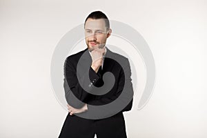 Close up portrait of beautiful bearded businessman with stylish hairstyle wearing black suit