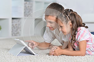 Close-up portrait of beautiful boy and girl with tablet pc