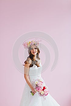 Close-up portrait of beautiful bride with flower wreath on her head