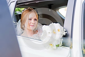 Close-up portrait of a beautiful bride in a wedding car window. The concept of wedding happiness.