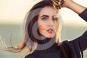 Close-up portrait of beautiful brunette woman outdoors