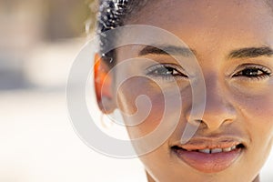 Close-up portrait of beautiful caucasian young woman smiling and looking at camera, copy space