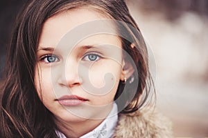 Close up portrait of beautiful child girl looking at camera