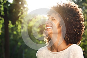 Close up portrait of beautiful confident woman laughing in nature