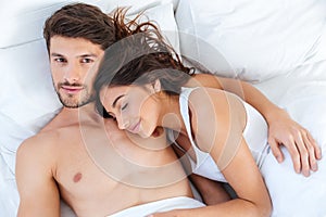 Close-up portrait of a beautiful couple lying in bed